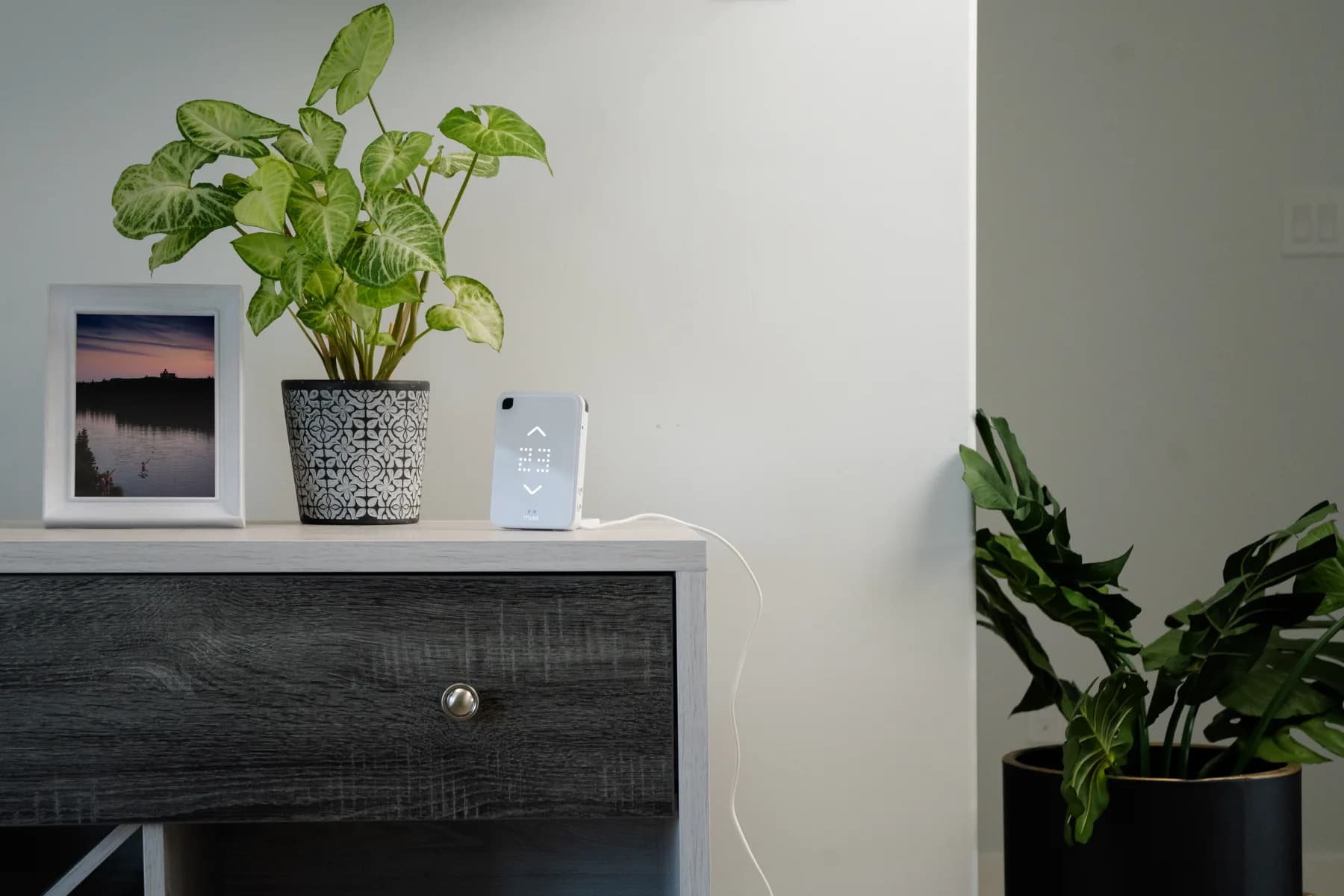 Mysa Smart AC controller on a sideboard in a living room